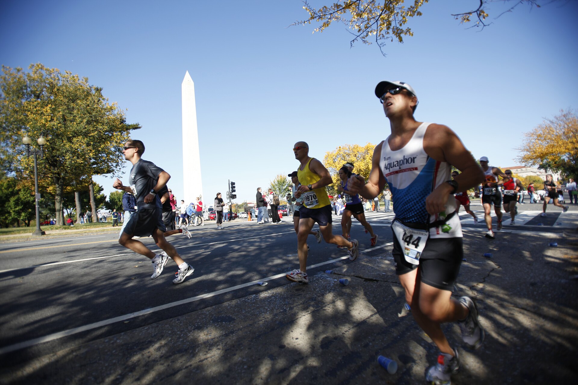 Marine Corps Marathon runners passing the Washington Monument on 14th Street around mile 16